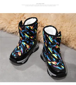Detail view of kids fur-lined snow boots featuring colorful graffiti print and white fleece lining