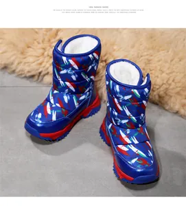 Detailed macro view of kids' blue patterned snow boots with warm white faux fur lining