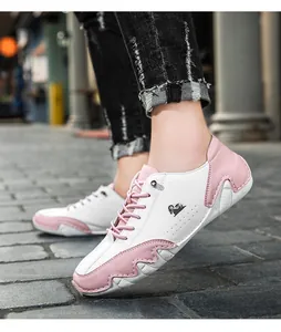 Close-up of pink and white casual sneakers with unique octopus traction sole design