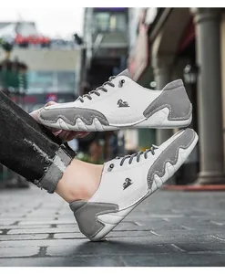 Detailed side view of grey and white color-blocked low-top casual shoes with wavy sole.