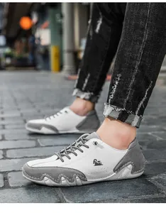 Close-up of men's casual white and grey low-top sneakers with octopus-style sole.