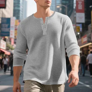 Primer plano del tejido de punto gofrado y el cuello con botones de una camiseta Henley