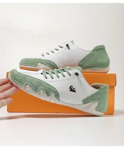 Detail view of white and green low-top leisure shoes with octopus-style sole