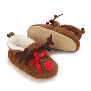 Detail view of adorable reindeer infant shoes with warm fleece lining and red bow accents