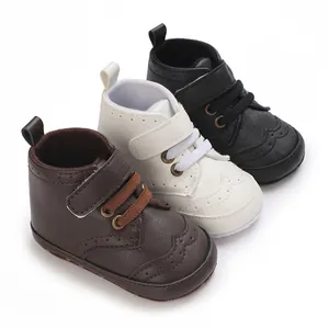 Detail view of high-top baby boots in brown, white, and black with soft soles