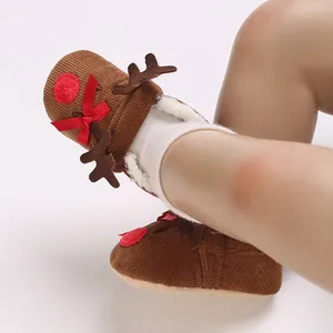 Close-up of reindeer-themed brown corduroy baby shoes with white fleece lining