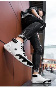 Detail view of white high-top leather boots with black accents on a male model in urban street.