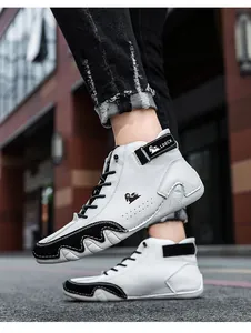 Close-up of white leather high-top boots with black color-blocked details and laces