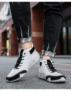Close-up of modern white and black high-top casual boots on a street style model