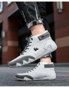 Detail shot of white high-top leather boots with grey suede accents and LDECK logo.