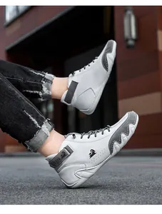 Close-up of white and grey leather high-top boots with ram logo detail.