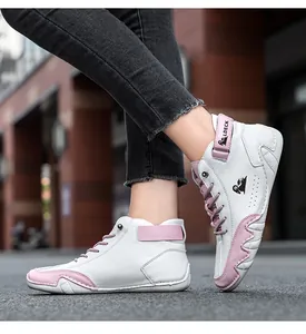 Detail shot of white and pink high-top leather casual boots with lace-up design