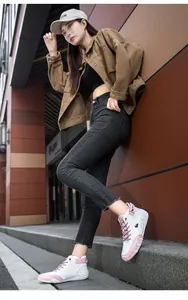 Lifestyle shot of women wearing pink and white high-top casual sneakers outdoors.
