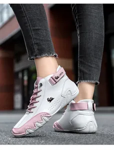 Close-up side view of white and pink high-top leather casual boots with decorative logo