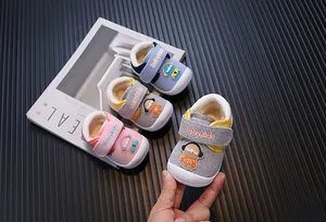 Detailed view of warm plush infant walking shoes with cute cartoon and velcro strap