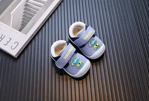 Close-up detail of warm blue plush-lined toddler walking shoes with cute astronaut decor