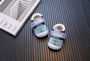 Macro view of light blue baby walking shoes with astronaut decor and warm lining