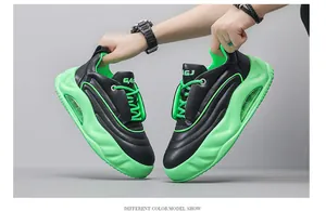 Detail of chunky men's sneakers in black and neon green with thick air cushion soles