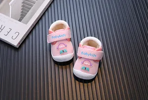 Close-up of pink fleece-lined baby walking shoes with cute cartoon astronaut design