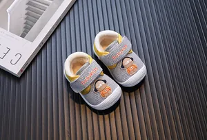 Close-up of warm baby walking shoes with fleece lining and astronaut detail