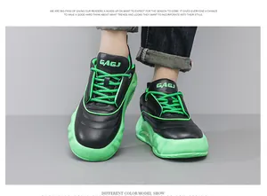 Close-up view of black platform bread sneakers with neon green laces and chunky soles