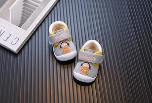Close-up of grey fleece-lined baby walker shoes with cartoon character patch detail