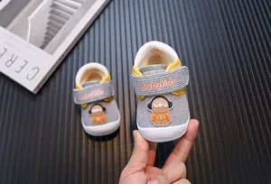 Detail view of warm fleece-lined toddler walking shoes with cute cartoon character