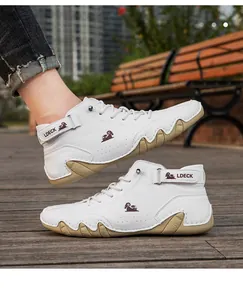 Detail shot of white high-top octopus shoes with LDECK brand and tan wavy sole