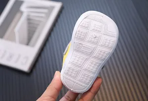 Close-up of white anti-slip rubber sole for toddler walking shoes with size 16 marking