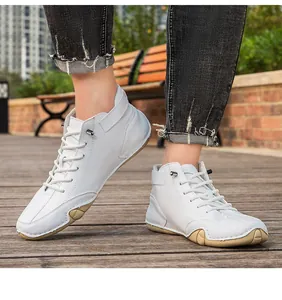 Detailed view of white high-top casual boots with octopus-style anti-slip soles
