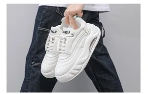 Detailed view of trendy white platform chunky sneakers for men with air cushion