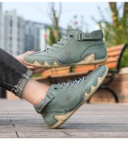 Detailed side view of men's green octopus sole casual ankle boots in outdoor setting