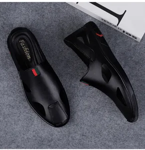 Close-up view of black men's closed-toe leather sandals featuring side cutouts and a stripe