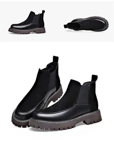 Détail de la texture en cuir noir et daim des bottines Chelsea pour hommes avec semelle crantée.