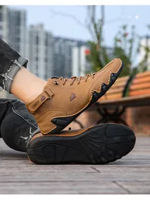 Detailed view of brown high-top casual boots with unique wavy octopus non-slip rubber sole