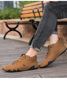 Close-up of men's brown high-top casual martins boots worn in a stylish outdoor park.
