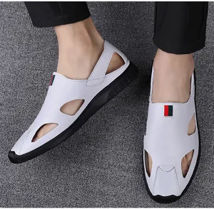 Macro view of men's white hollow-out leather sandals with stylish red green ribbon