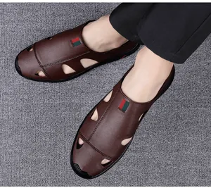 Close-up detail view of men's brown leather hollow-out sandals with striped web accent