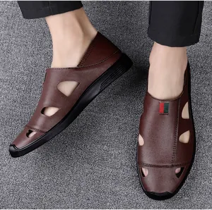 Macro view of men's soft brown leather closed-toe sandals with breathable cut-outs.