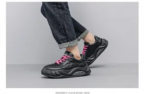 Side view of black men's chunky sneakers with pink laces and a thick air cushion sole.
