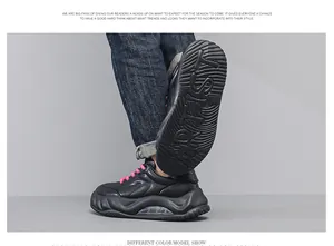 Detailed side view of chunky black men's sneakers with pink laces and air cushion sole.