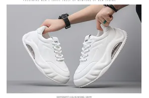 Close-up detail of white chunky men's sneakers featuring thick air cushion soles