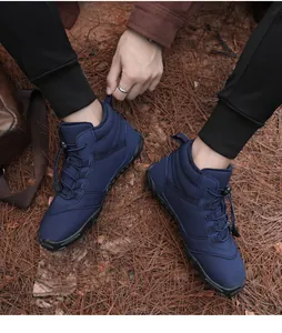 Detailed view of men's blue winter boots featuring warm fur lining and quick toggle laces