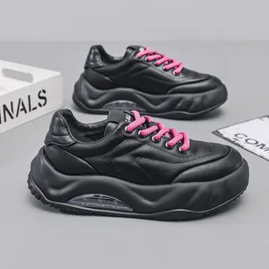 Stylish chunky black dad sneakers with pink laces and a visible air cushion platform sole