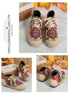 Detailed view of ethnic style high-top linen shoes with totem print and platform sole