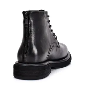Rear view of black leather Martin boots showing back zipper and thick sole detail.