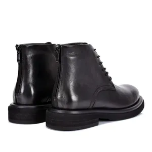 Close-up rear view of black leather Martin boots featuring back zipper and thick sole