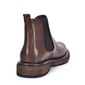 Detailed back view of a classic dark brown genuine leather Chelsea boot with a thick sole