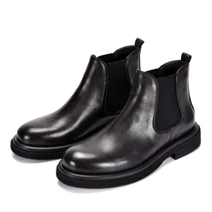 Detailed side view of black genuine leather men's Chelsea boots with thick soles