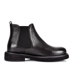 Detailed side profile view of premium black leather Chelsea boots for men with thick sole